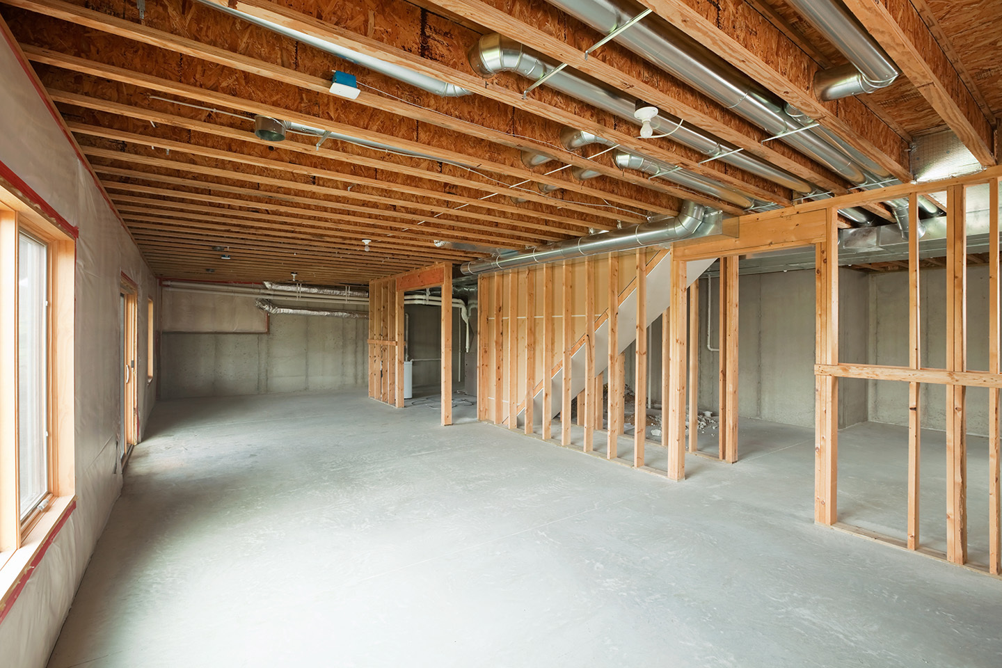 Interior construction site with a concrete subfloor and wall framing