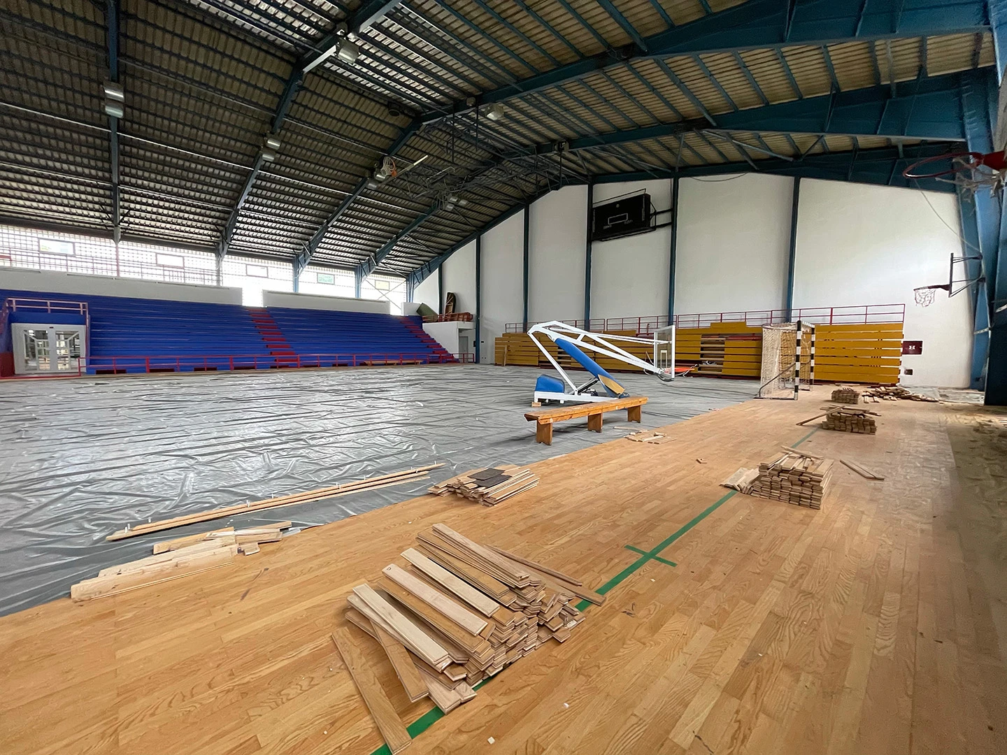 Gymnasium wood floor being replaced with new wooden planks