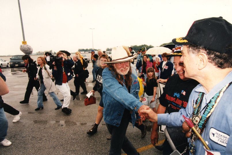Willie Nelson shaking hands with a farmer